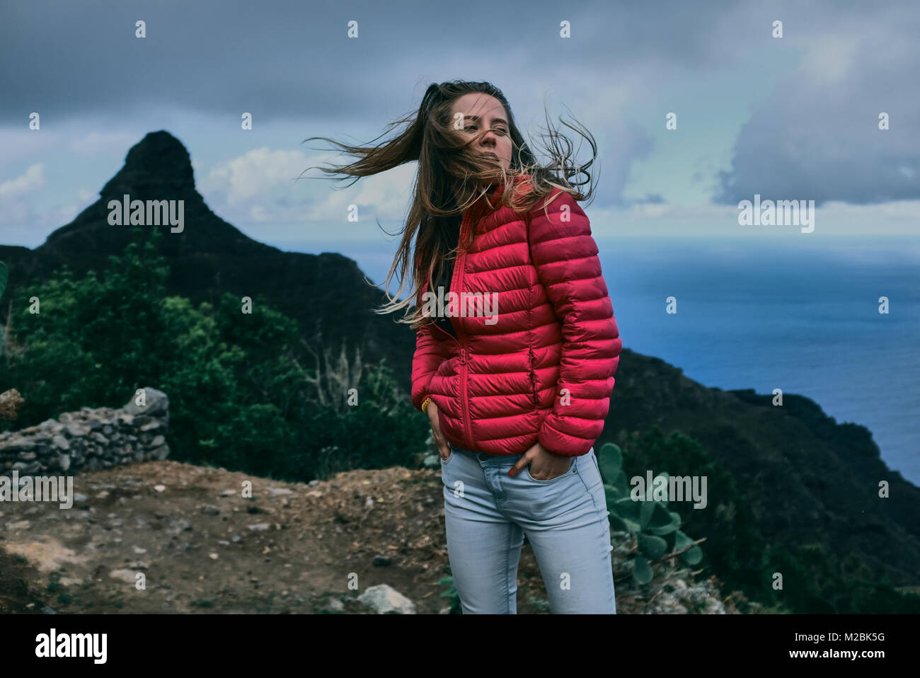 Pretty girl of background of mountain landscape Stock Photo - Alamy