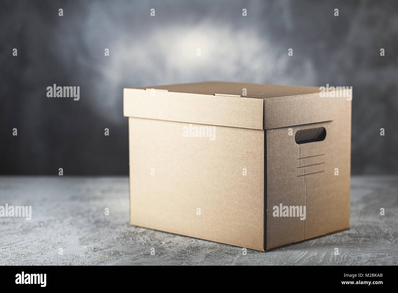 Cardboard box on grey background Stock Photo
