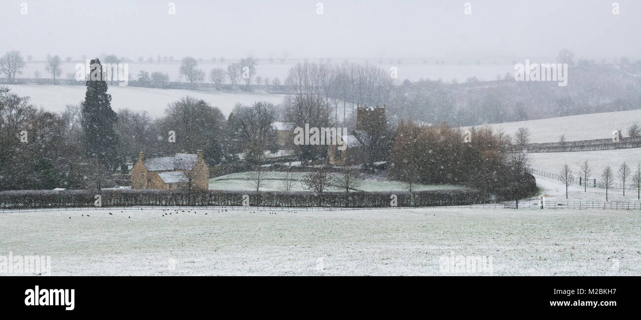 St Philips Church in Little Rollright in the winter snow. Cotswolds, West Oxfordshire, England. Panoramic Stock Photo
