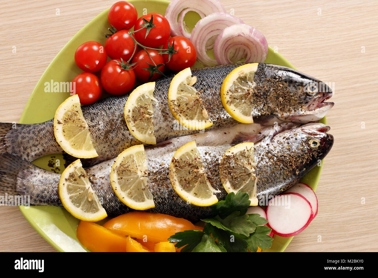 trout fish with vegetables on plate Stock Photo