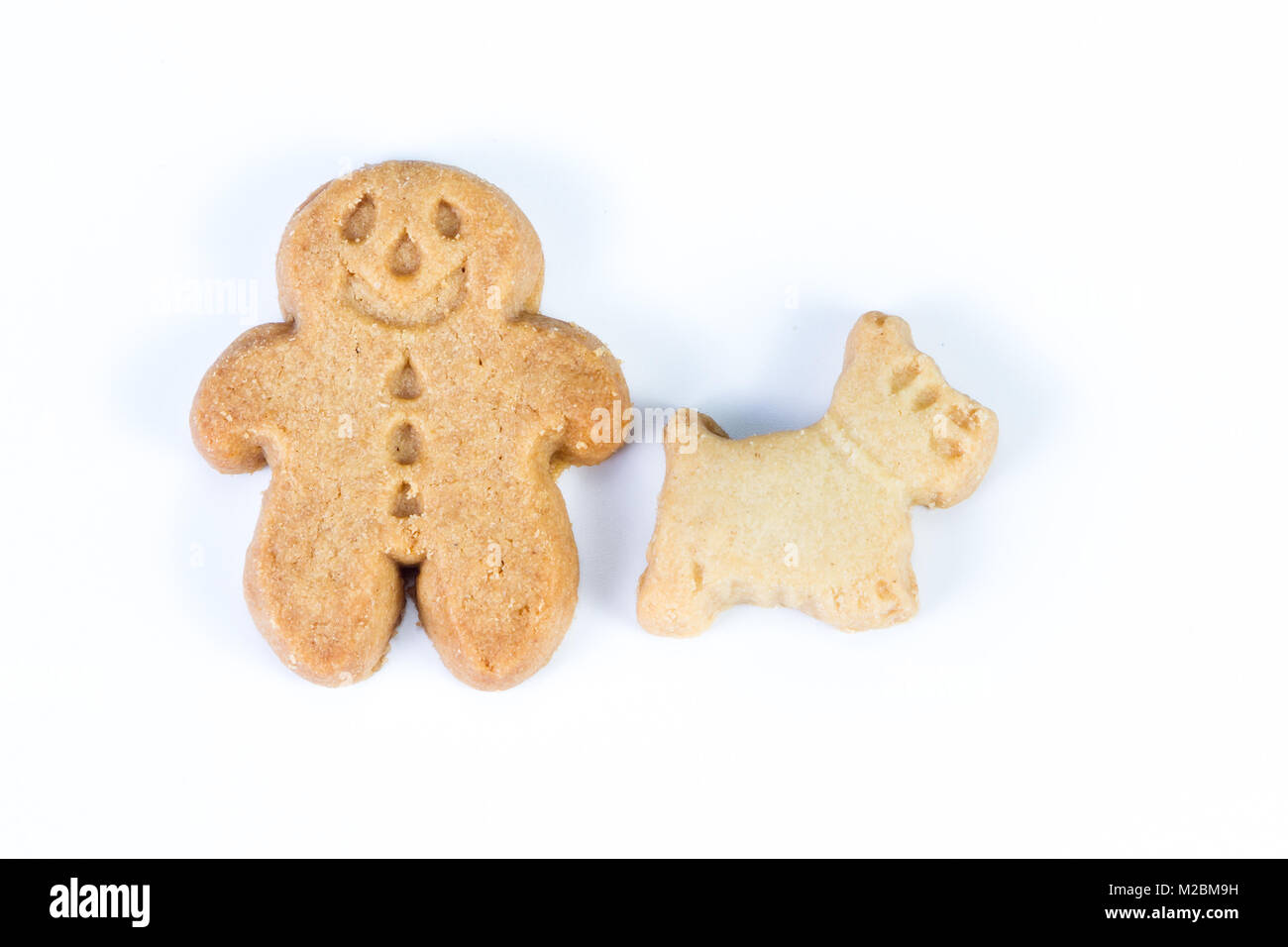 group of gingerbread man standing together with their scotty dog on a white background Stock Photo