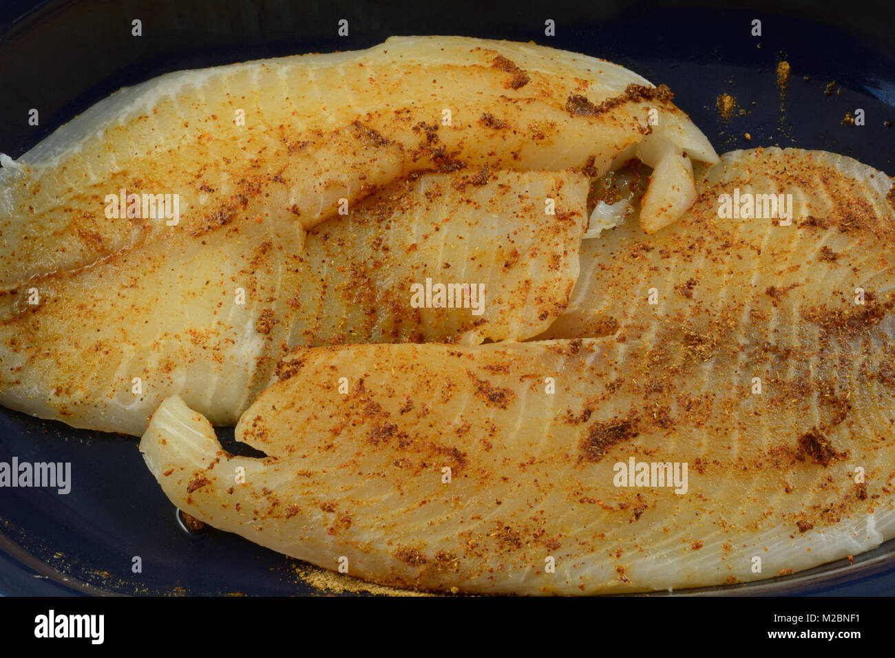 Close up of fresh raw tilapia fish fillets prepared for cooking with