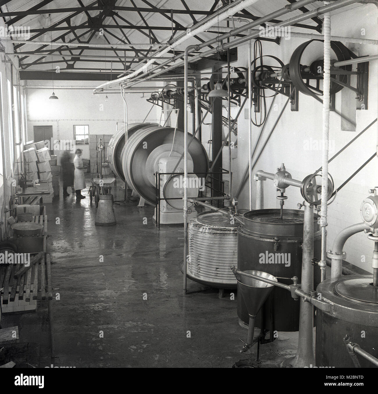 1950s, historical picture of the interior of an industrial creamery in