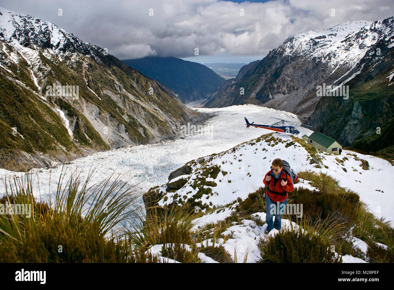 New Zealand, South Island, Fox Glacier, Tourist going trekking after being dropped by helicopter at Chancellor Hut. Unesco, World heritage site. Stock Photo