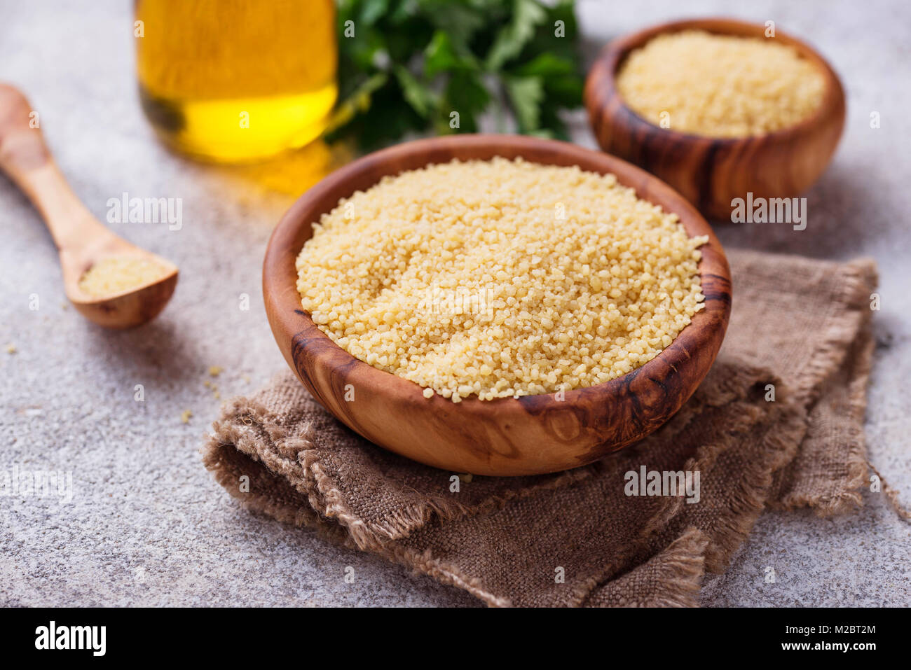 Couscous grain in wooden bowl Stock Photo Alamy