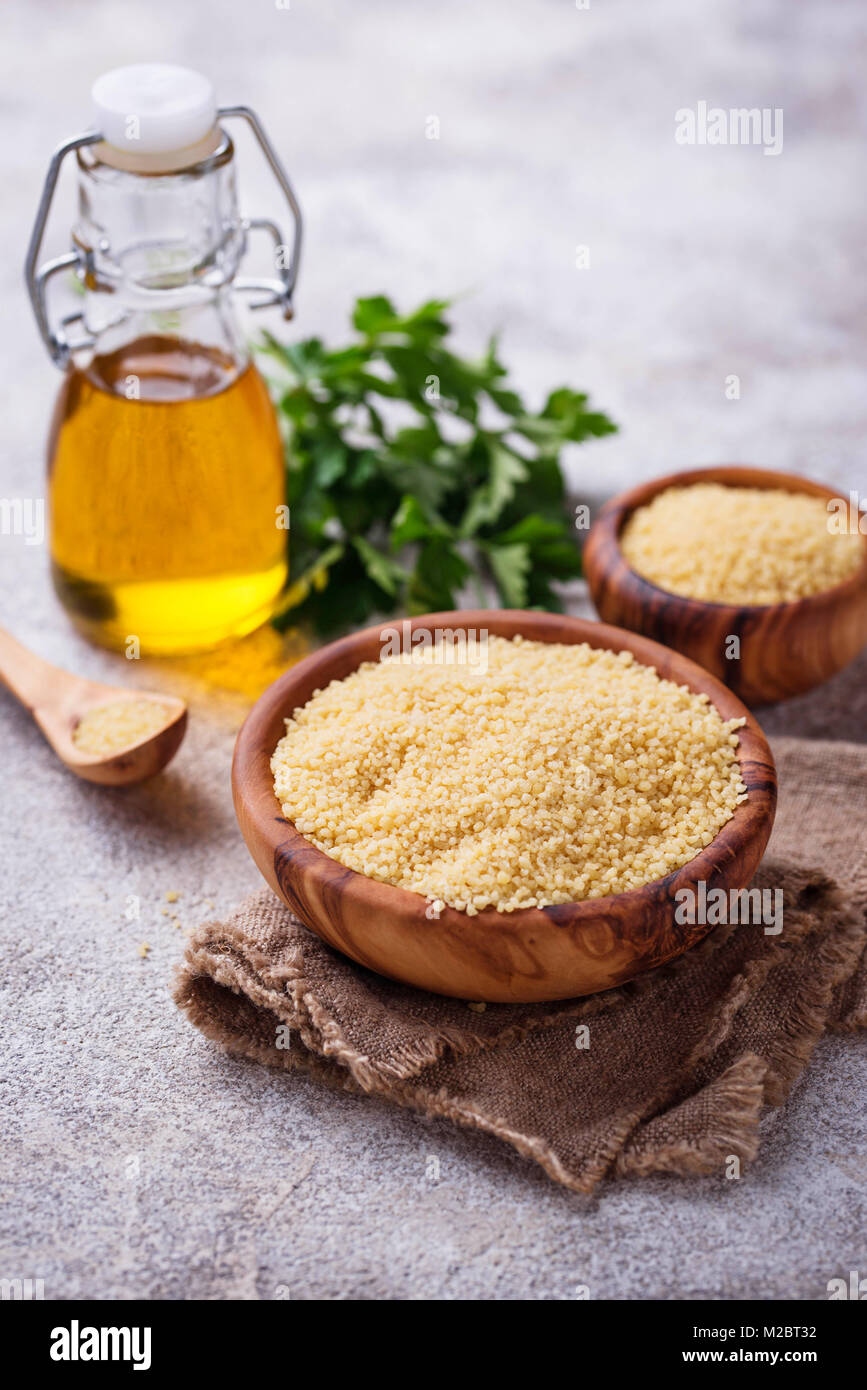Couscous grain in wooden bowl Stock Photo Alamy