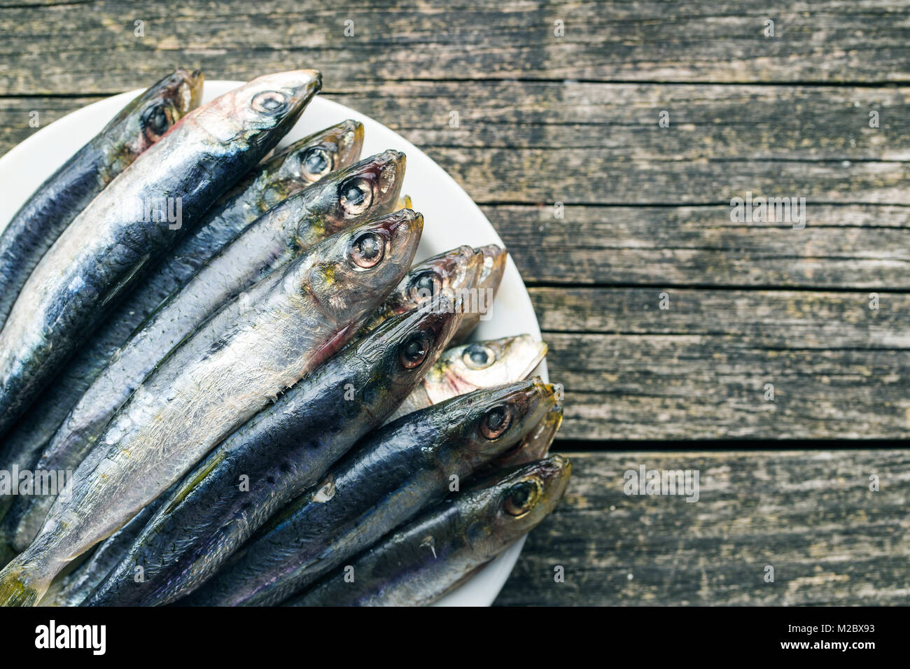 Raw sardines fish on plate. Top view Stock Photo Alamy