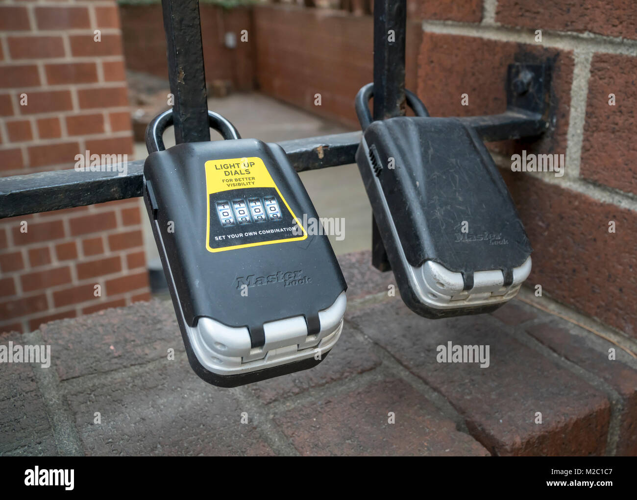 Lockboxes attached to a gate outside an apartment building in the Chelsea neighborhood of New York on Friday, February 2, 2018. The boxes are commonly used to distribute keys to apartments that are being rented out via apartment sharing services such as AirBnB. A recent study by McGill Urban Planning estimates that AirBnB has increased long-term rental leases in the city by 1.4 percent and has removed between 7000 and 13,500 rentals. (Â© Richard B. Levine) Stock Photo
