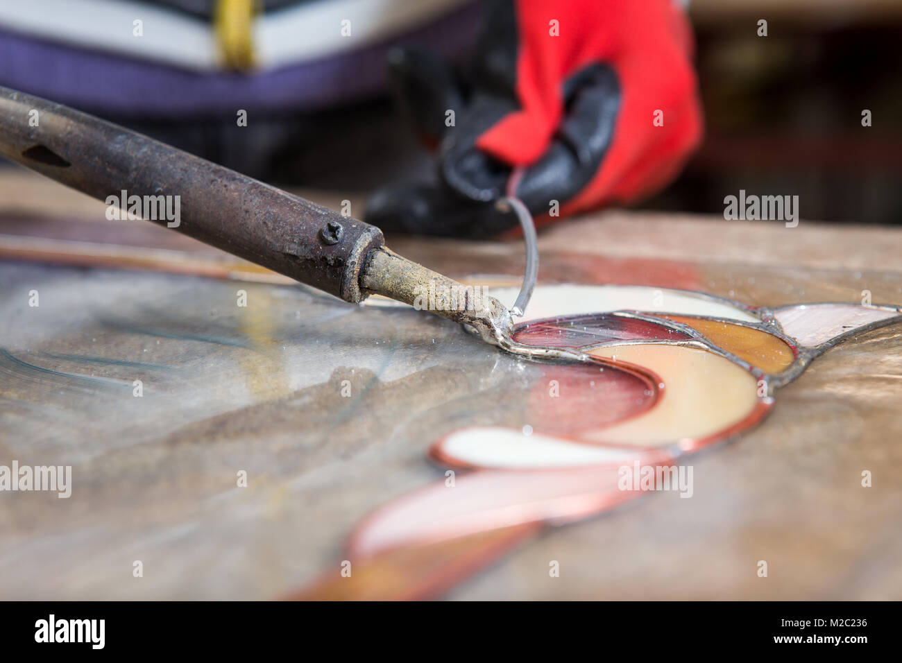 Stained glass maker works with colorful souvenirs Stock Photo Alamy