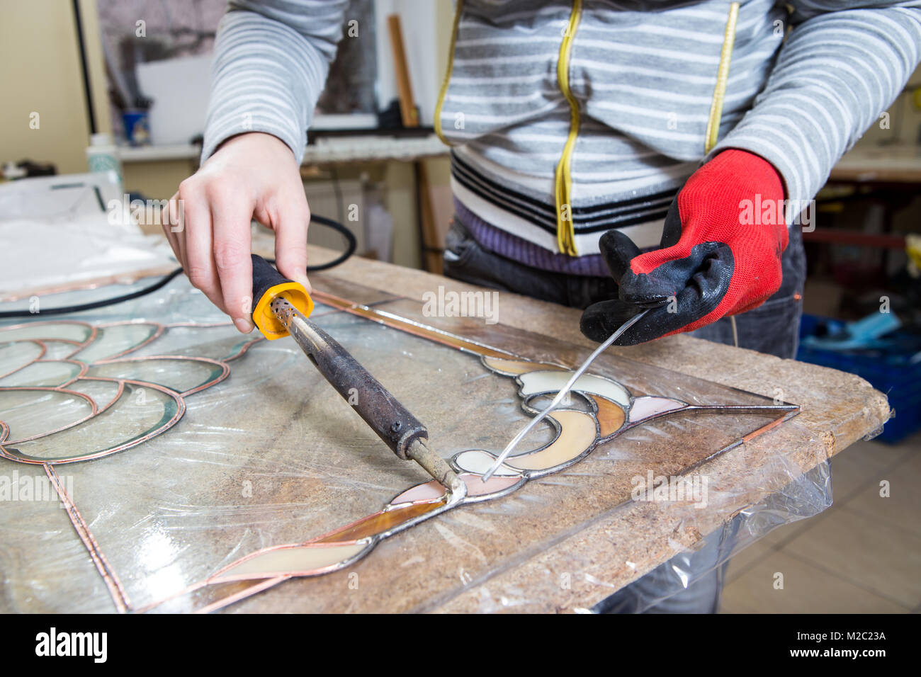 Stained glass maker works with colorful souvenirs Stock Photo Alamy