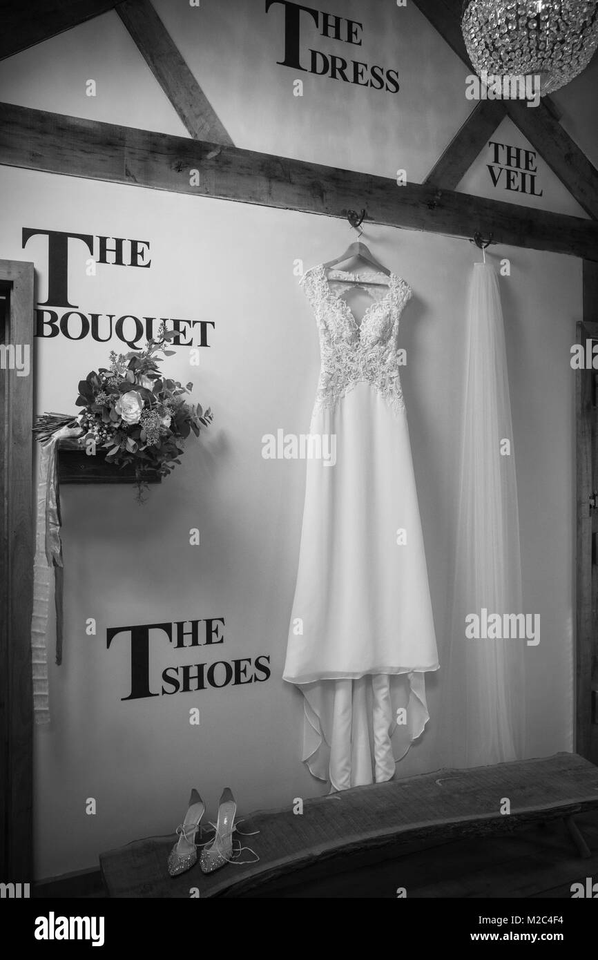 Bride's wedding dress and accessories hanging ready to wear, black and white Stock Photo