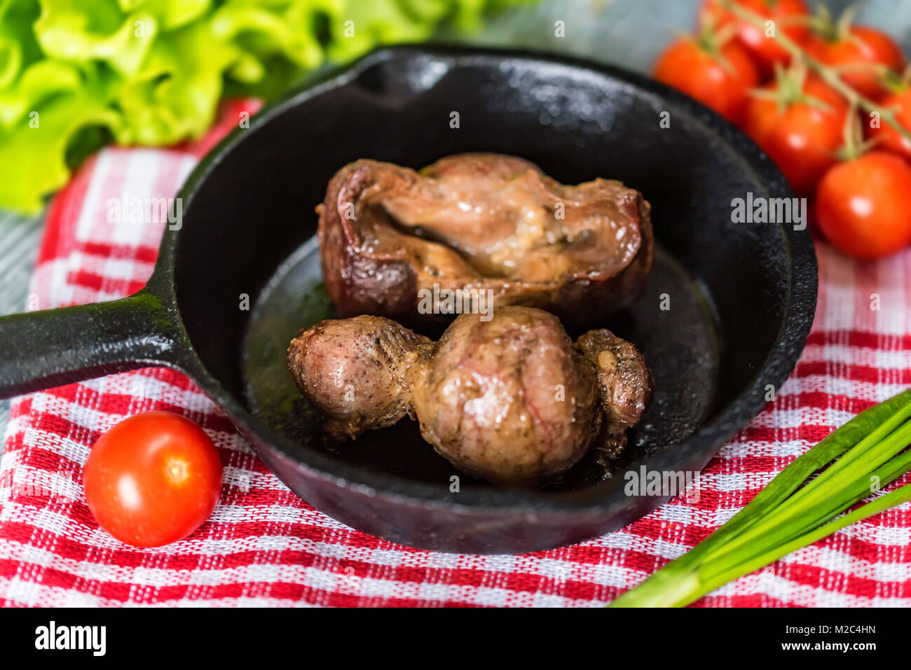 Tasty roasted chicken giblets in pan Stock Photo Alamy