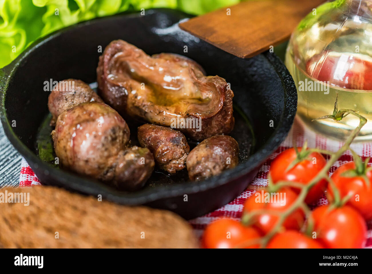 Tasty roasted chicken giblets in pan and rye bread Stock Photo Alamy