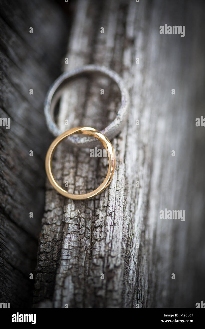 Two wedding rings on wooden surface, close-up Stock Photo