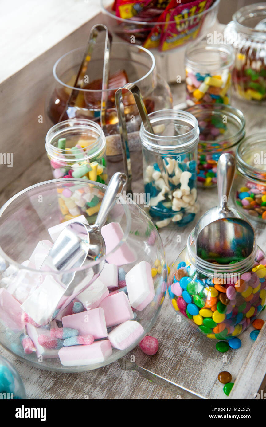 Selection of jars and bowls with colourful sweets Stock Photo