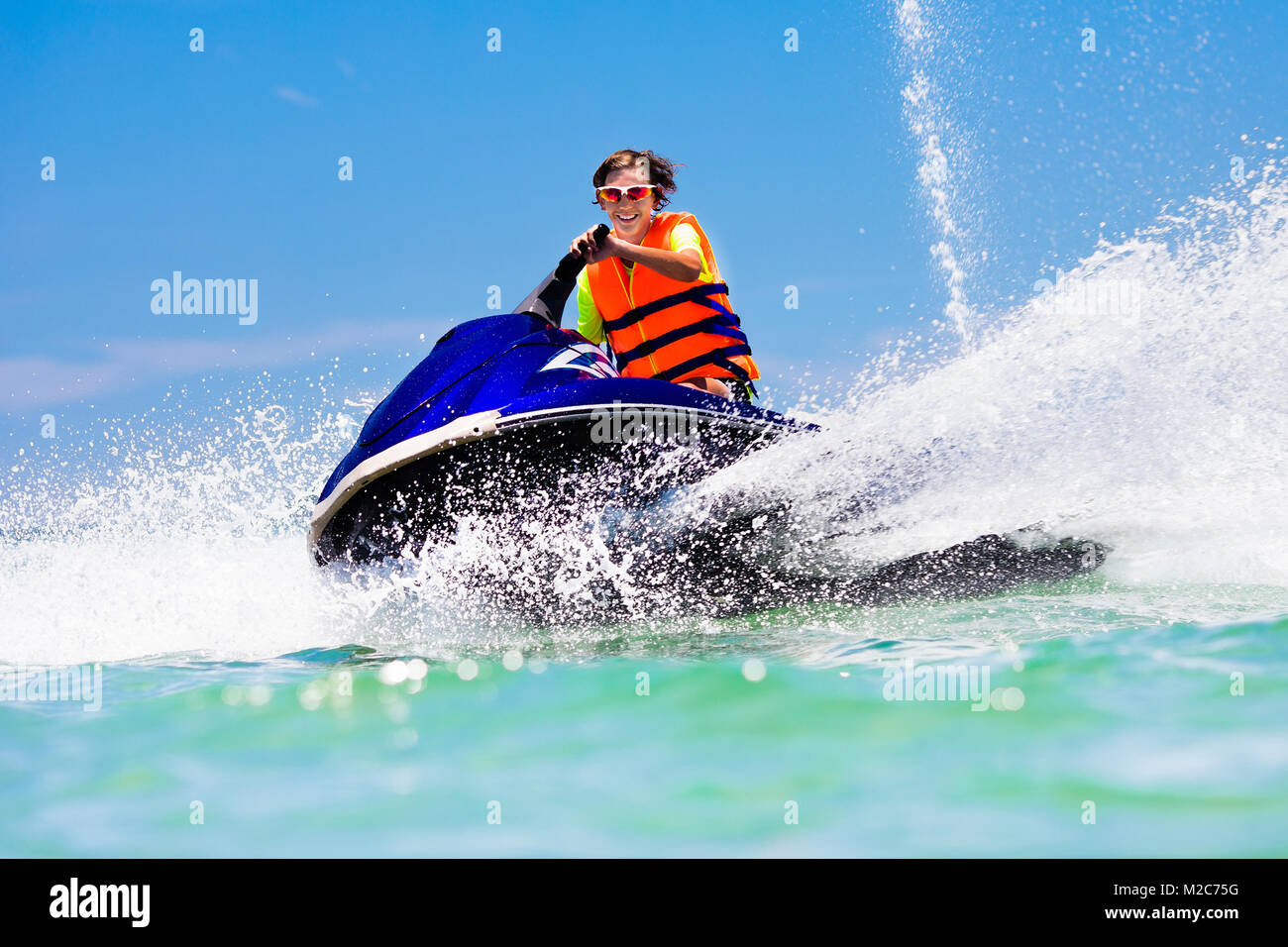 Måned pulsåre dø Teenager on jet ski. Teen age boy skiing on water scooter. Young man on  personal watercraft in tropical sea. Active summer vacation for school  child Stock Photo - Alamy