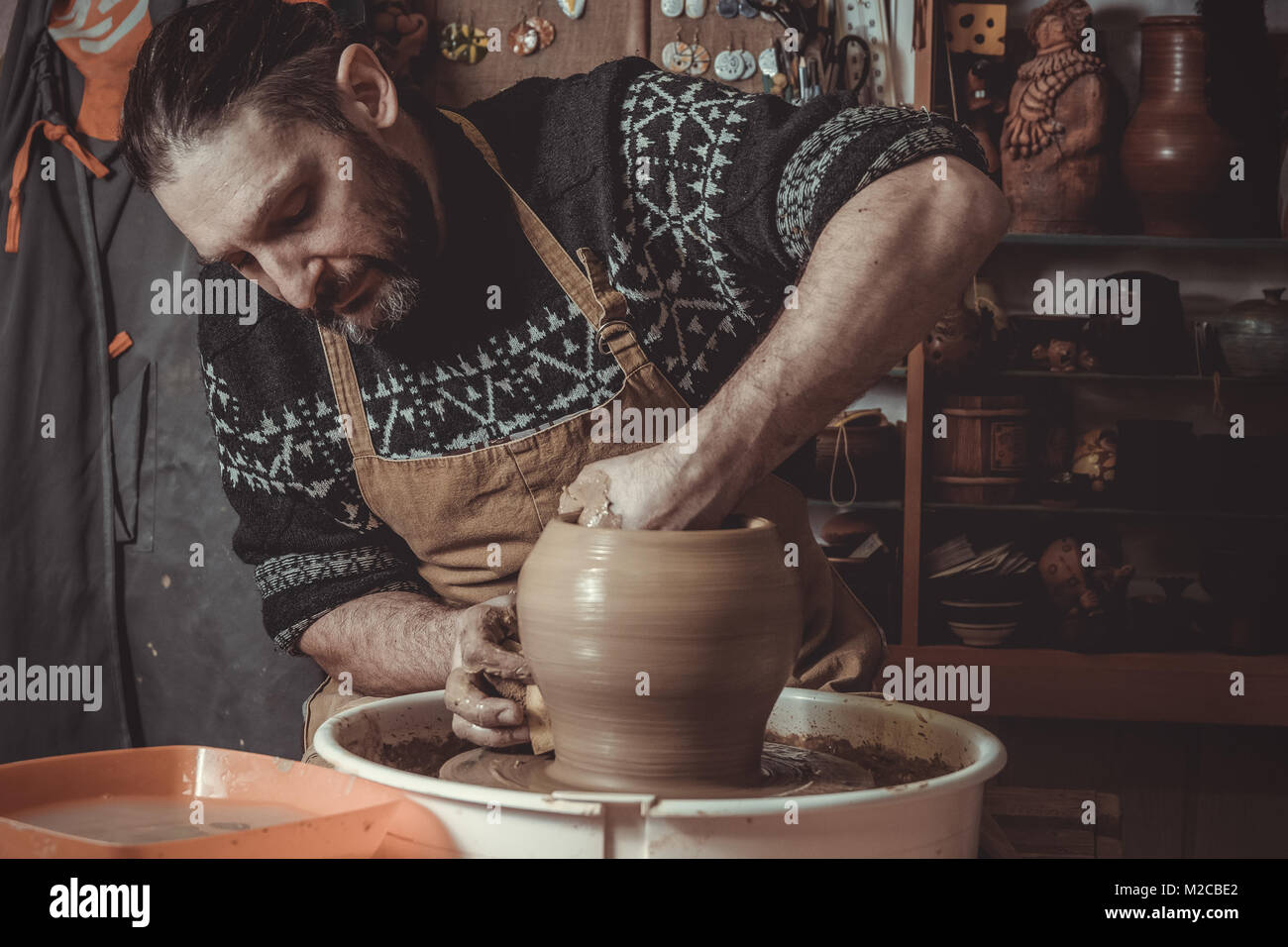 elderly man making pot using pottery wheel in studio Stock Photo Alamy