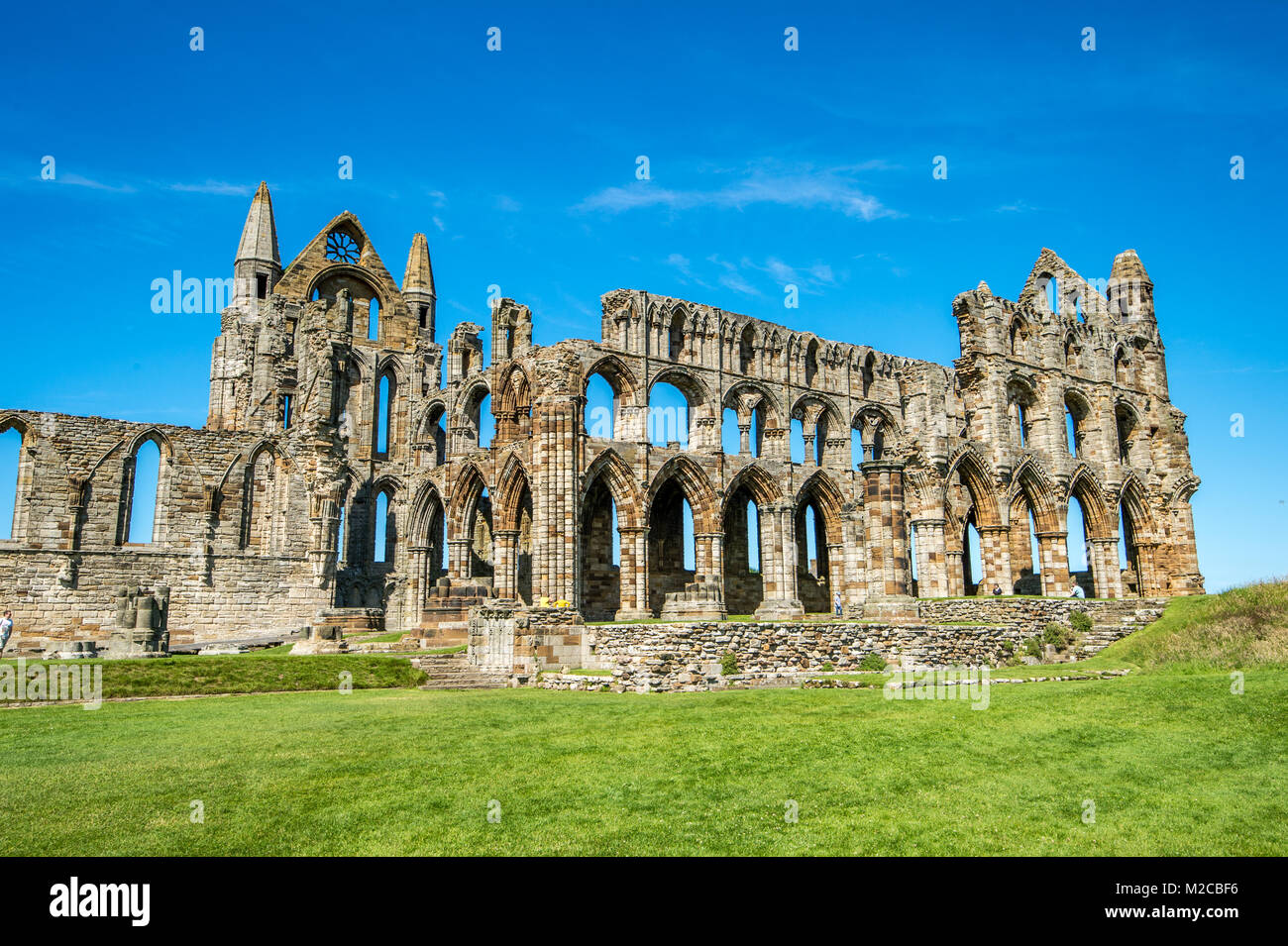 Ruins of Whitby Abbey stand out against clear blue skies, Whitby, Yorkshire, UK Stock Photo