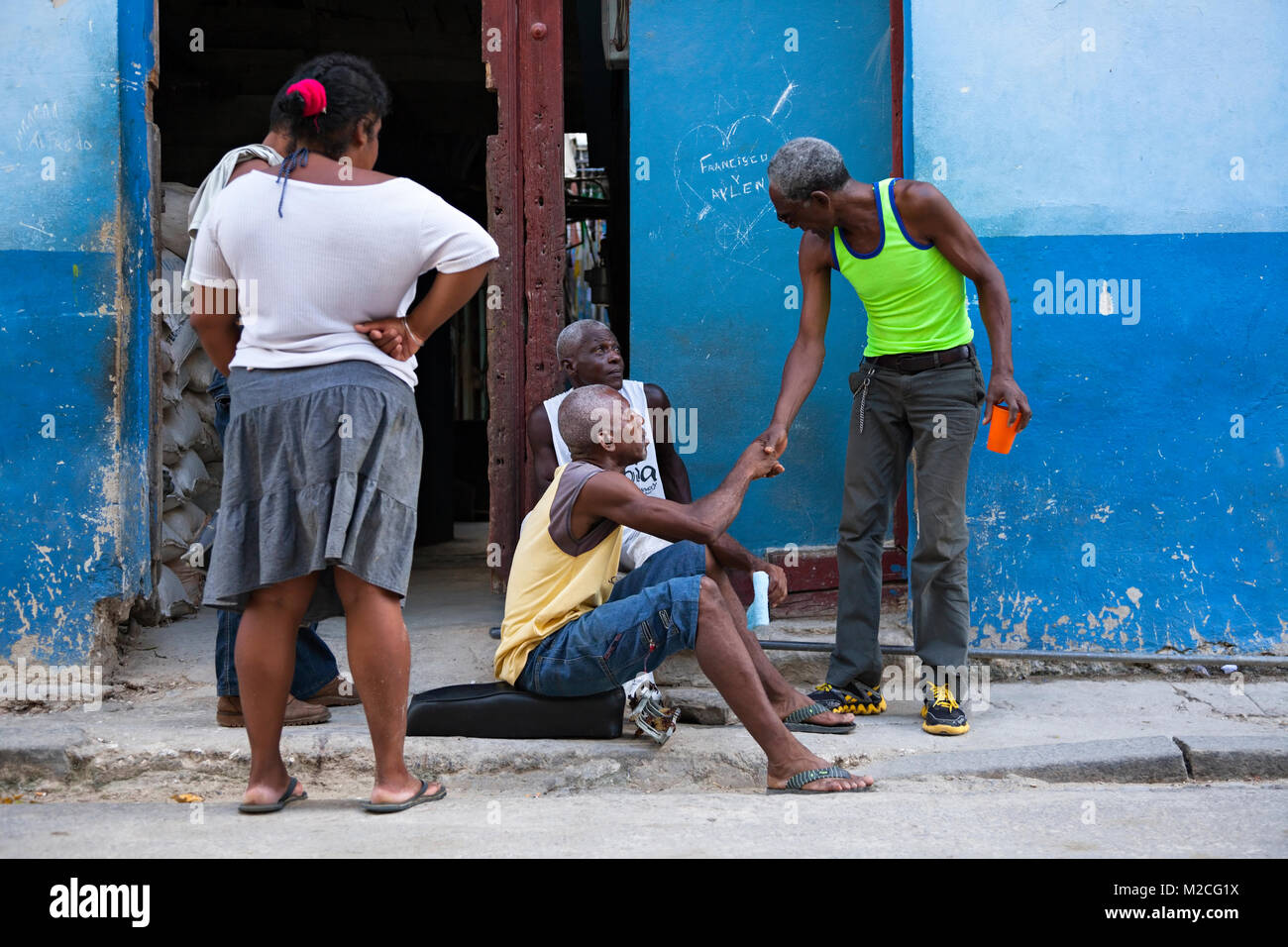 Cuban men greeting each other in Havana, Cuba. Stock Photo