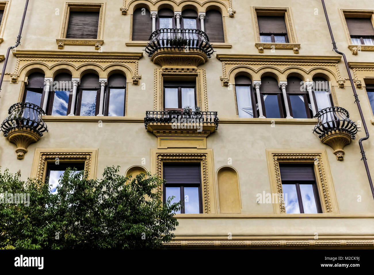 House building exterior facade with antique windows and balconies. Architect Gino Coppedè. Art Deco style. Rome, Italy EU. Close up, low angle view. Stock Photo