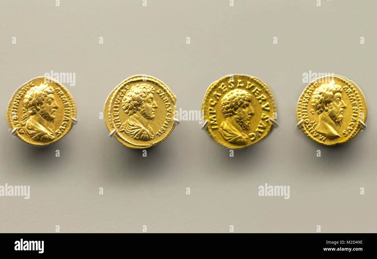 Merida, Spain - December 20th, 2017: Four golden coins of Marcus Aurelius Emperor at National Museum of Roman Art in Merida, Spain Stock Photo