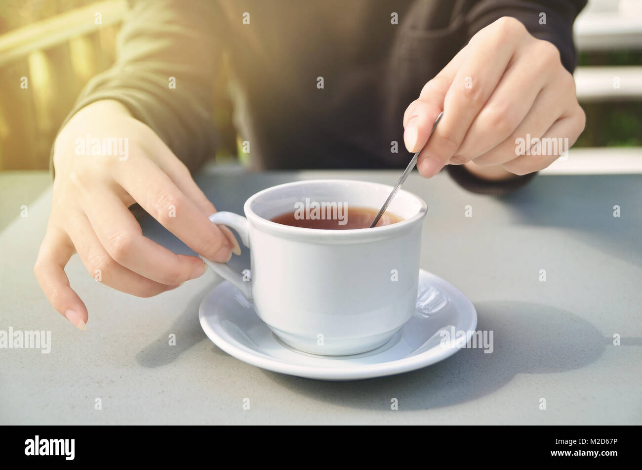 https://c8.alamy.com/comp/M2D67P/girls-hand-stirring-a-cup-of-tea-M2D67P.jpg