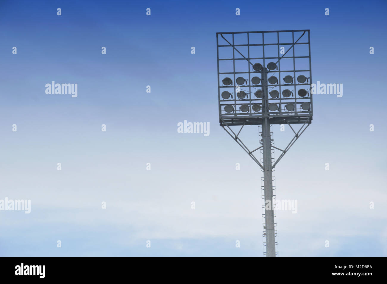 stadium light poles with white clouds and blue sky backgrounds Stock