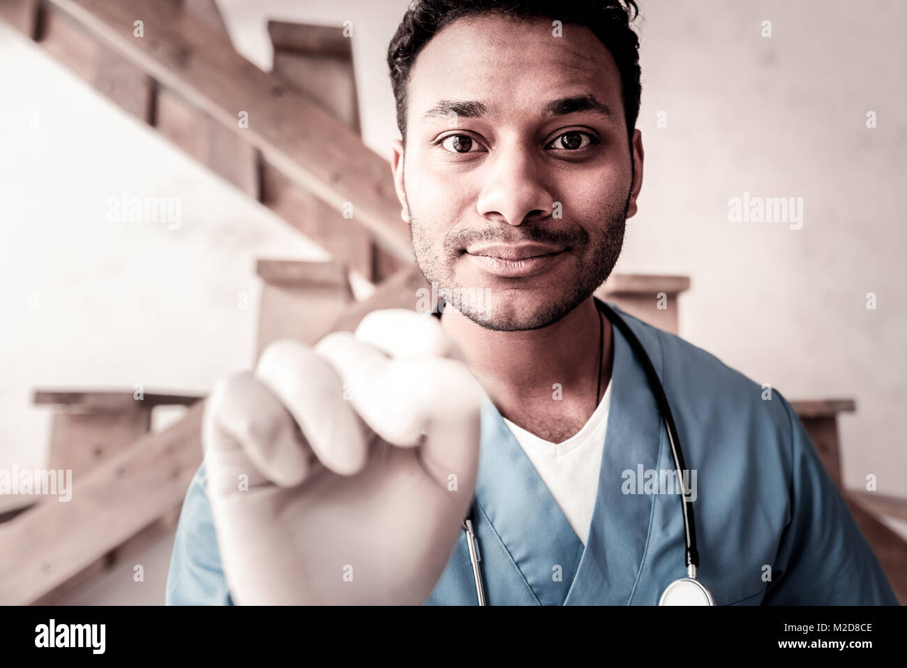 Smart male medical worker checking throat Stock Photo