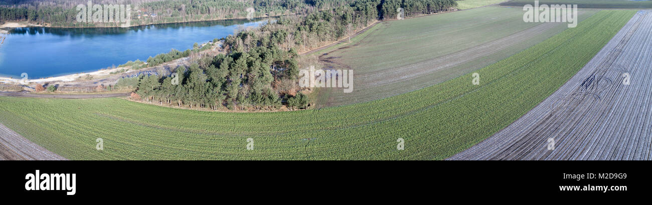 Aerial landscape photo, aerial photo with a lake, fields, meadows, forests and a road, panorama as a banner for a blog or a website, drone landscape p Stock Photo