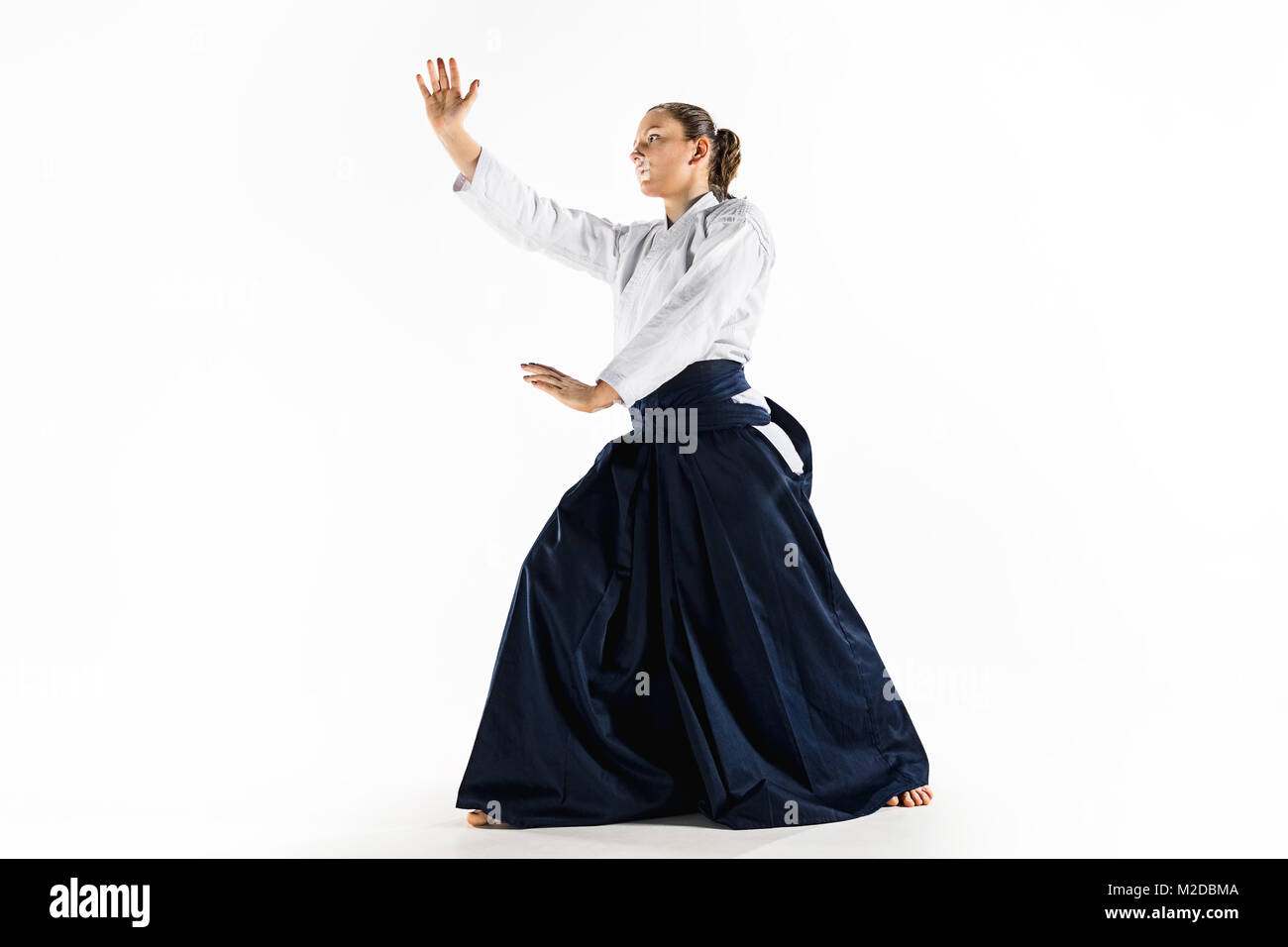 Aikido master practices defense posture. Healthy lifestyle and sports  concept. Woman in white kimono on white background Stock Photo - Alamy