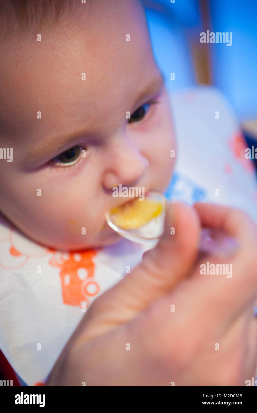 baby six months while eating pasta Stock Photo Alamy