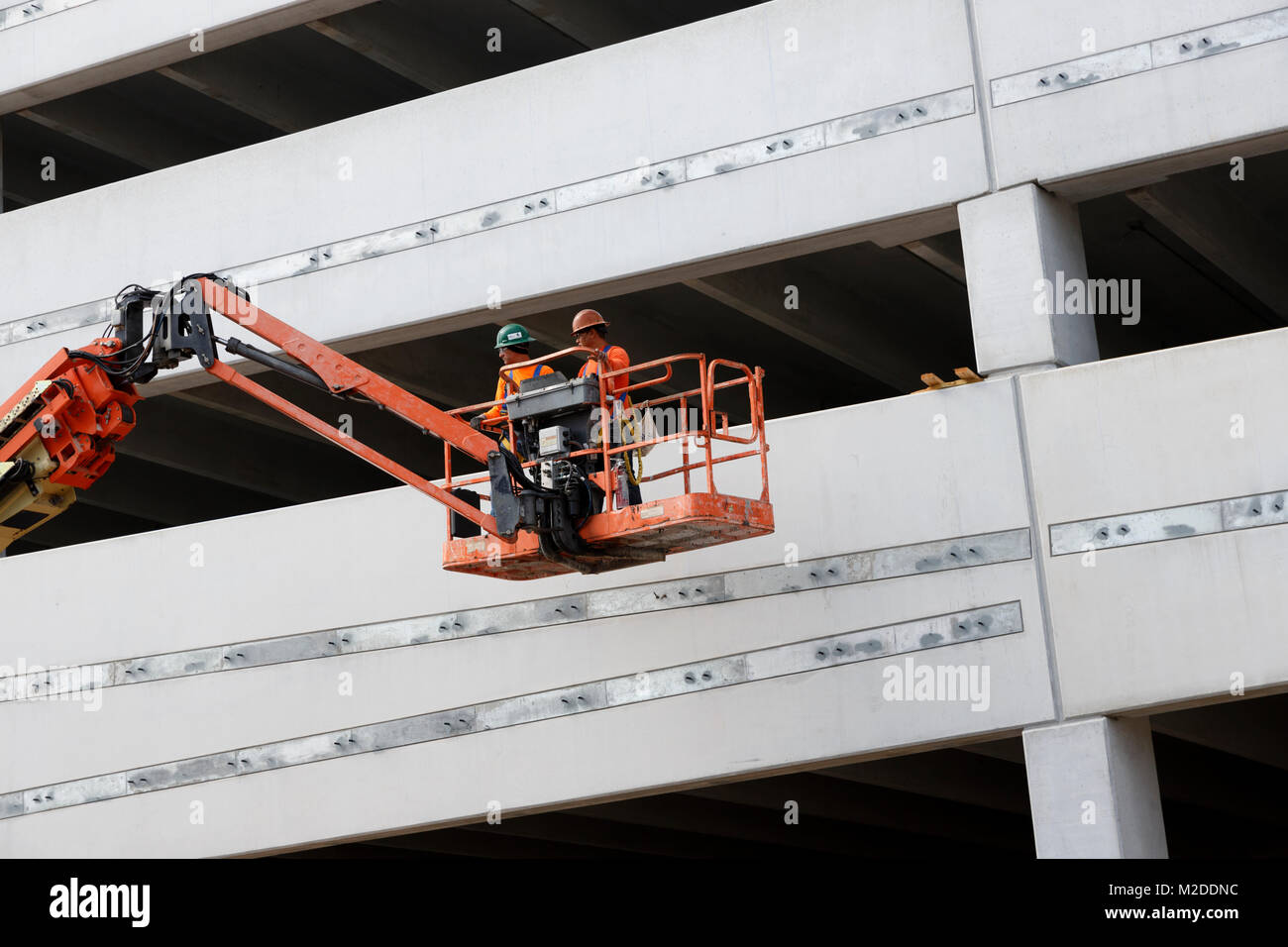 workers in a bucket lift, construction site, Miami, Florida Stock Photo