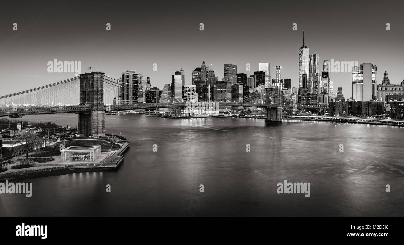 Sunrise on Lower Manhattan and the Brooklyn Bridge in Black & White. Financial District skyscrapers with East River. New York City Stock Photo