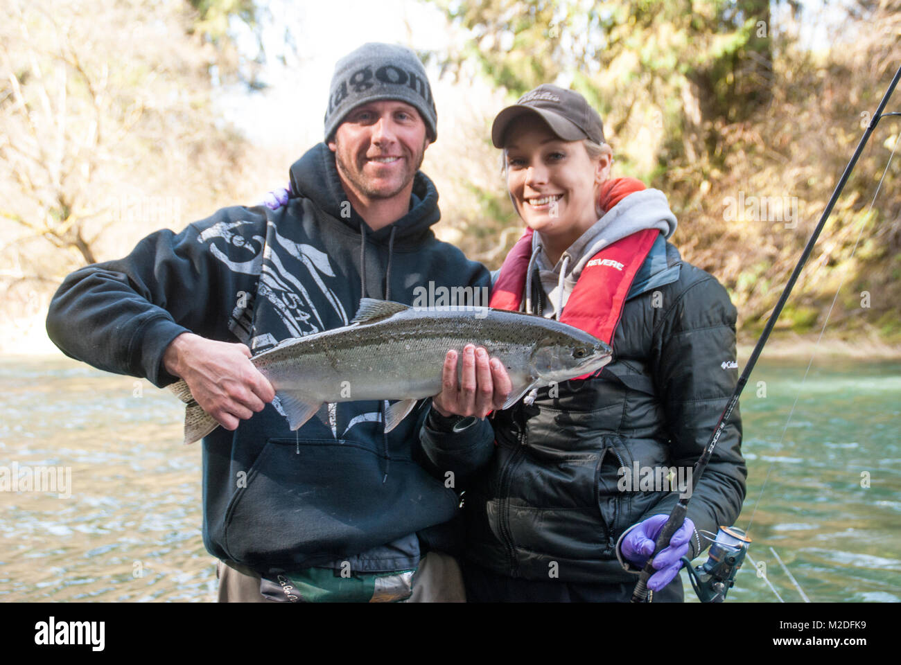 Couple with a hatchery raised Steelhead trout caught on Oregon's Siletz