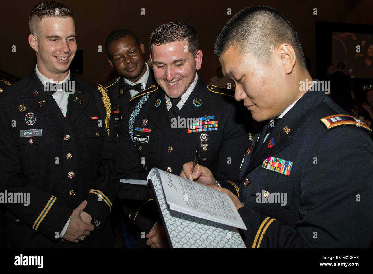 Dressed in their Army Service Uniforms, Soldiers from the 143d Sustainment Command (Expeditionary) sign a the black book during the during the Maj. Gen. Francisco A. Espaillat Victory Ball conducted at the Rosen Shingle Creek resort in Orlando, Fla., Dec. 16, 2017. The Victory Ball presented a unique opportunity for Soldiers assigned throughout the Command’s vast area of operations don their suits, gowns or dress uniforms and surround themselves with new and familiar faces in a fun and friendly atmosphere. (U.S. Army Stock Photo