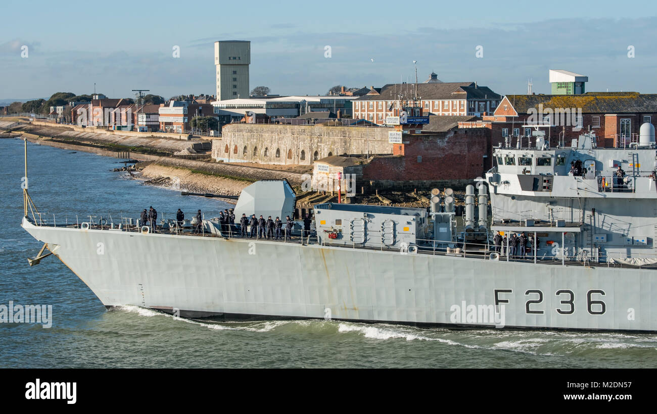 Comedian & TV Presenter Rhod Gilbert, is visible talking to crew members beside the gun turret on HMS Montrose as it leaves Portsmouth, UK on 5/2/18. Stock Photo