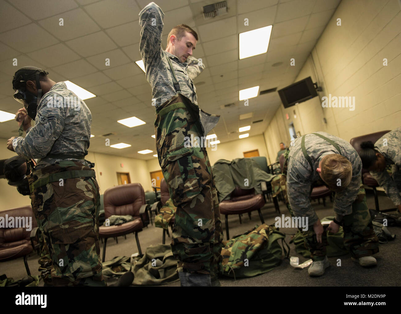 Airmen assigned to Altus Air Force Base, Okla., practice donning