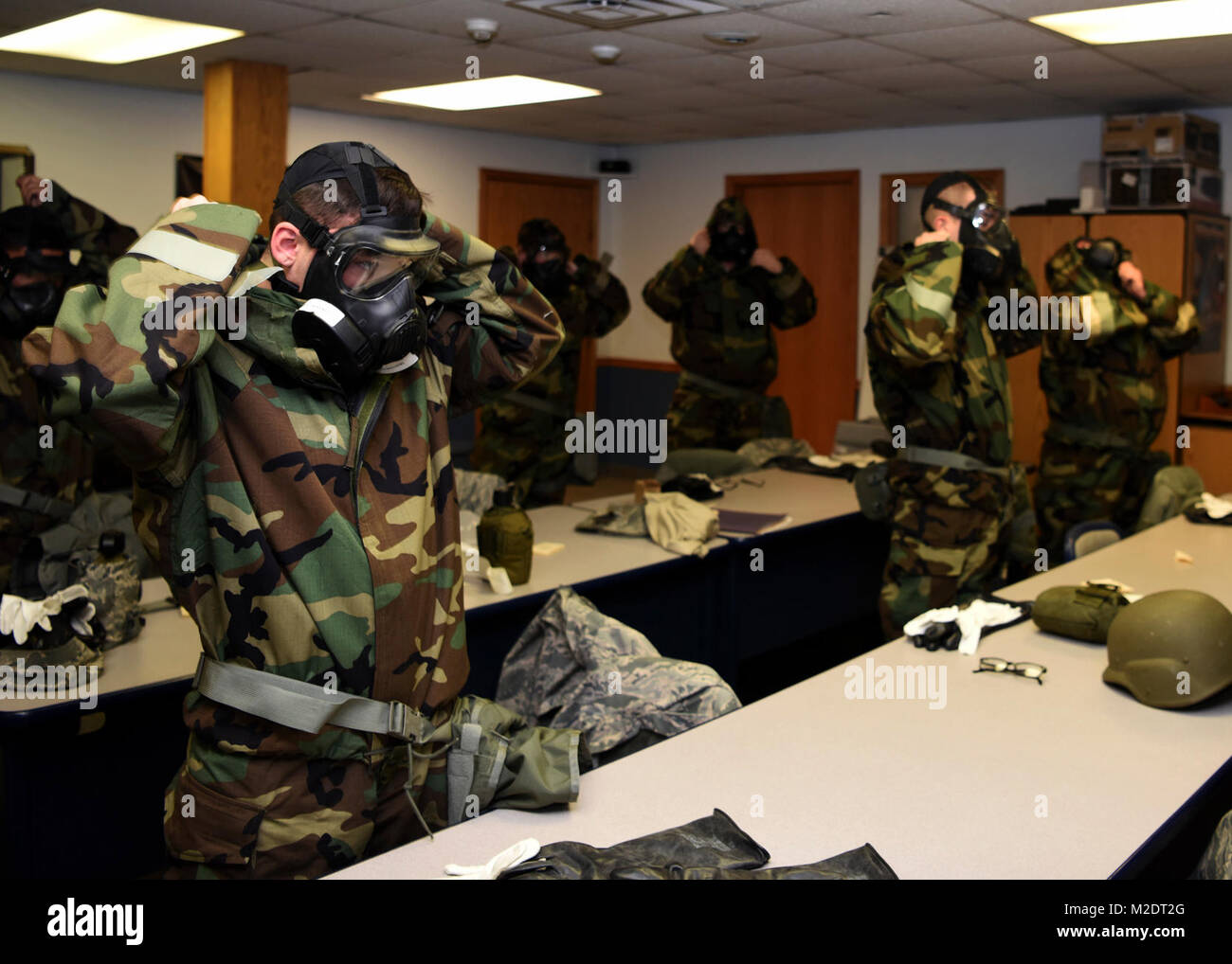 Airman put on mission oriented protective posture gear during training