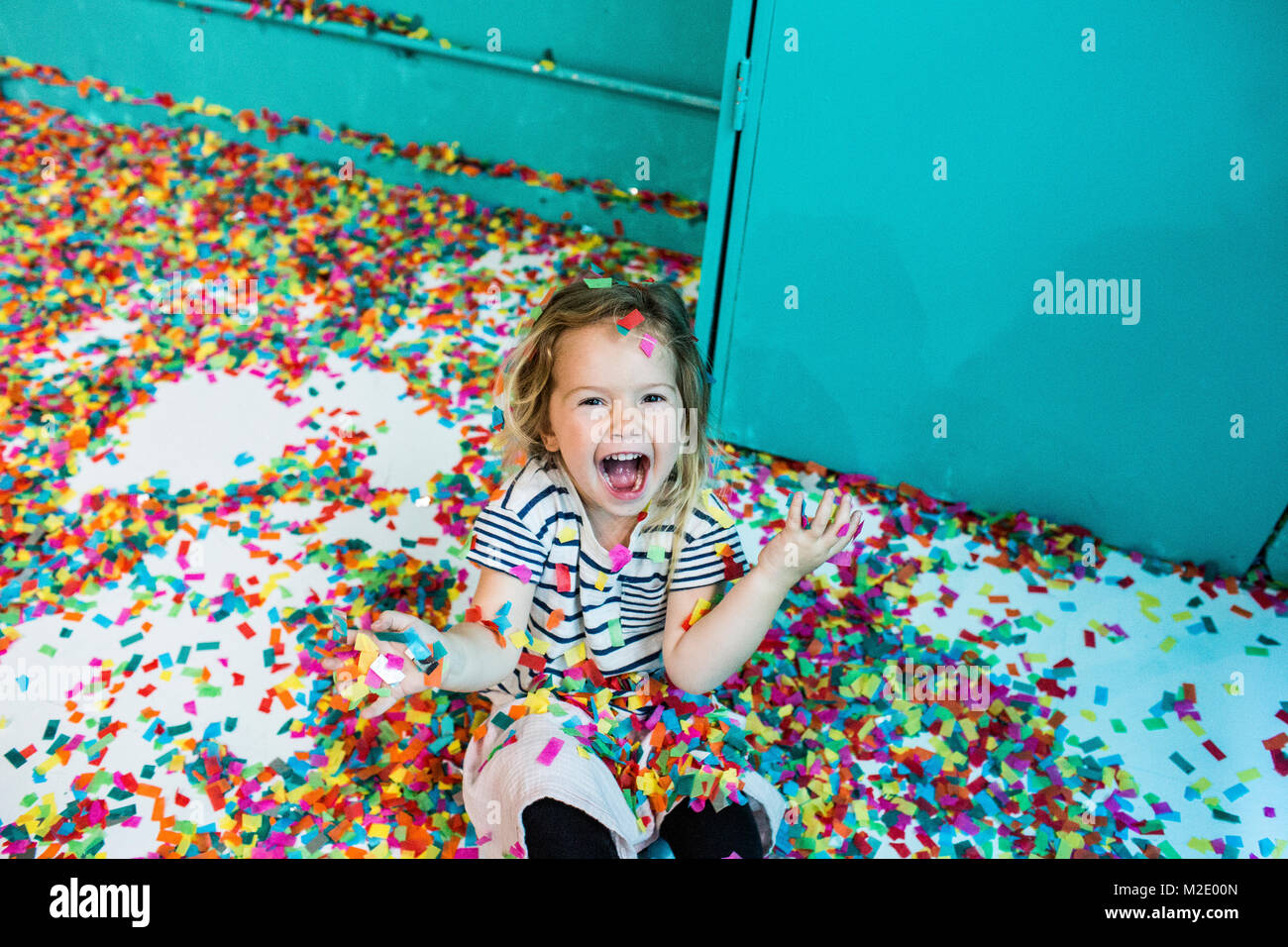 Colorful confetti falling on Caucasian girl Stock Photo