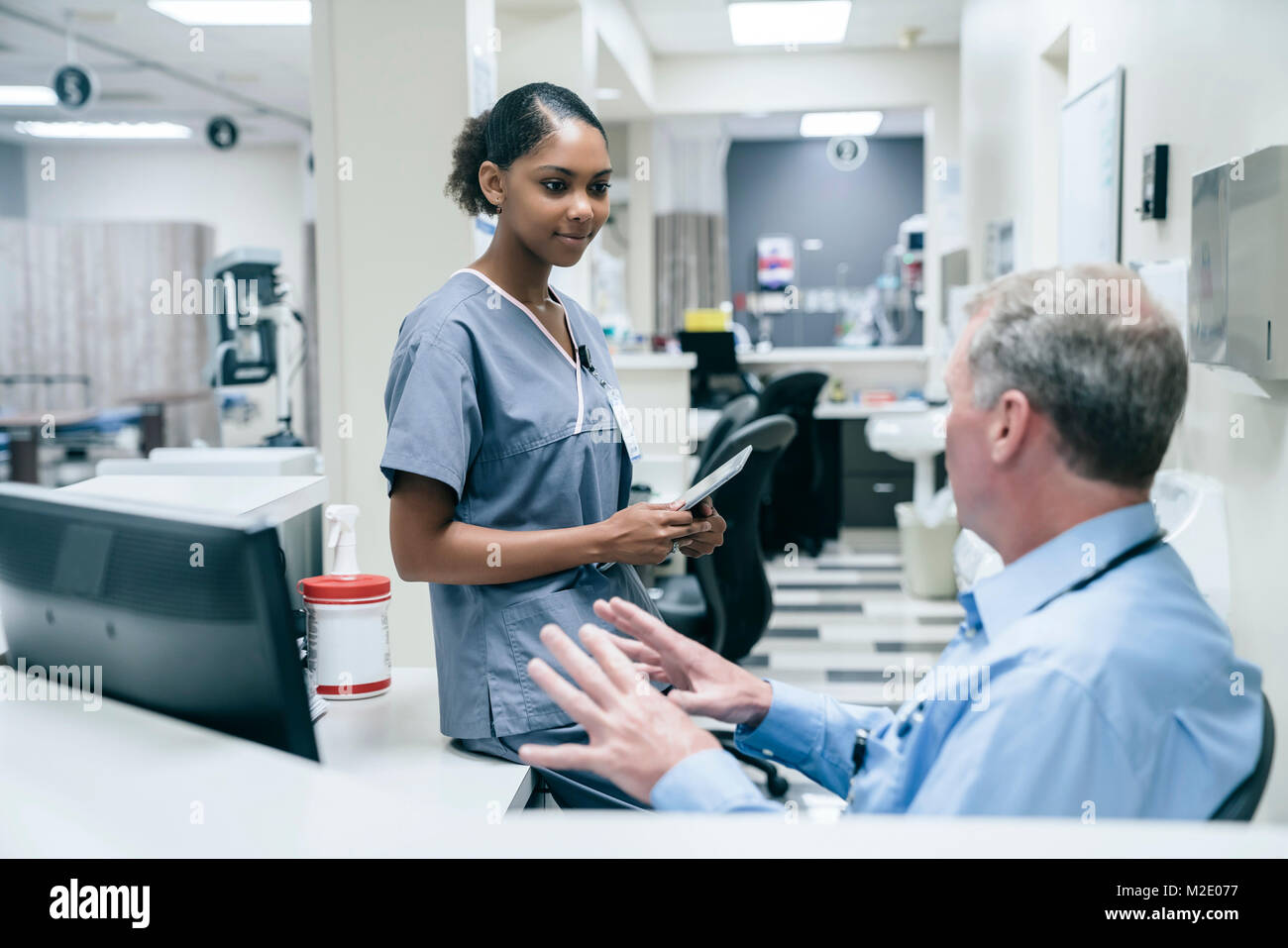 Doctor and nurse talking in hospital Stock Photo