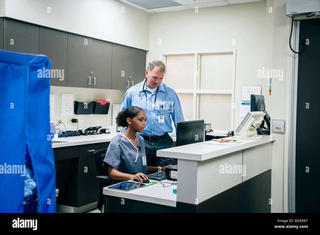 Doctor and nurse using computer in hospital Stock Photo