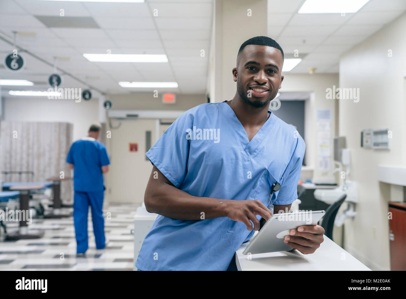 Portrait of smiling doctor using digital tablet in hospital Stock Photo