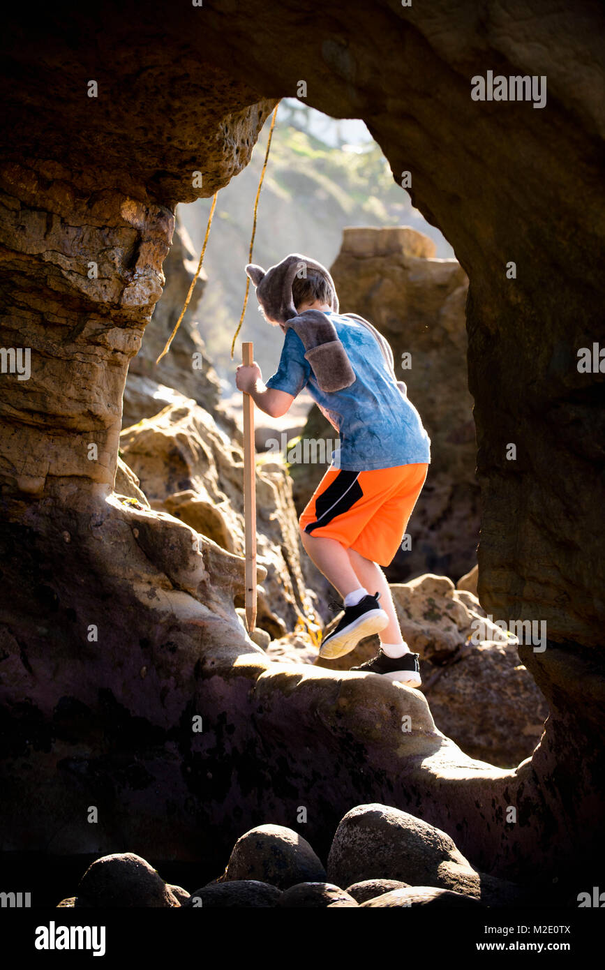 Caucasian boy hiking on rocks Stock Photo