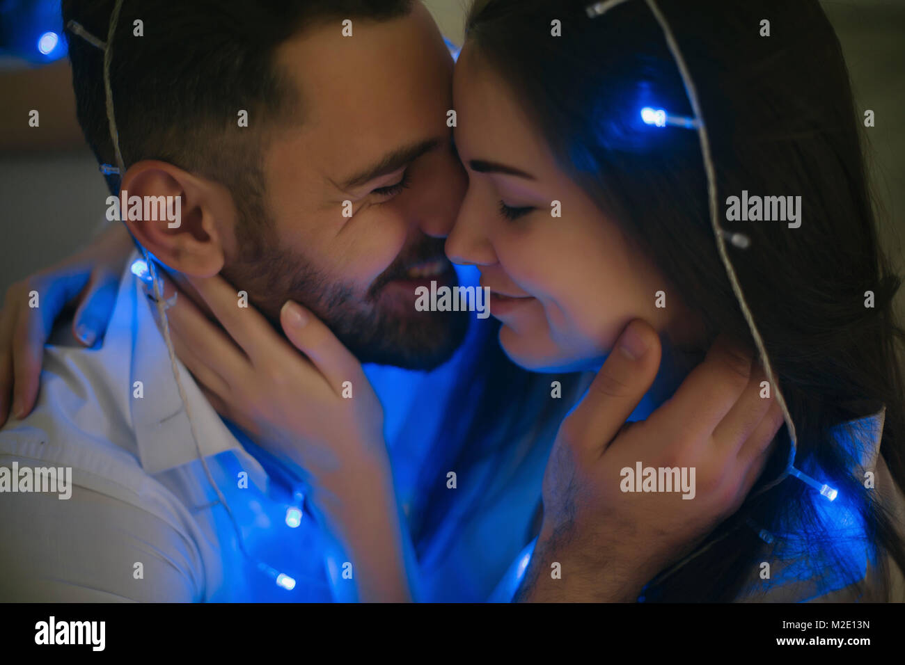String lights on embracing Caucasian couple Stock Photo - Alamy