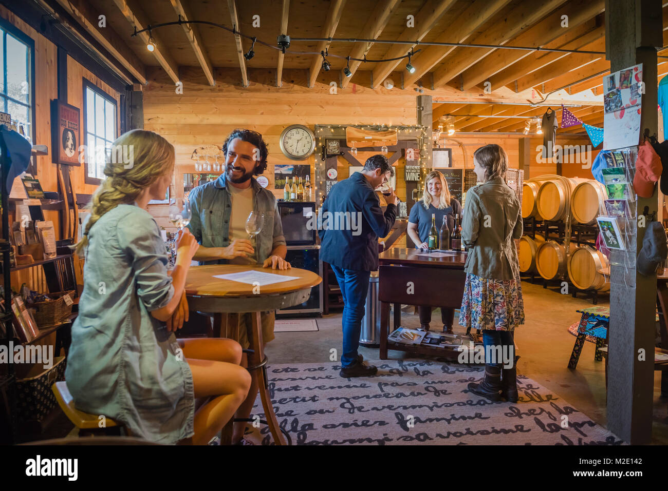 Caucasian people drinking wine in winery Stock Photo
