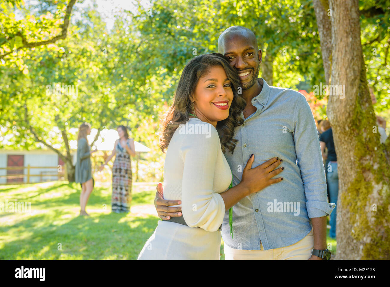 Portrait of smiling African American couple hugging outdoors Stock ...