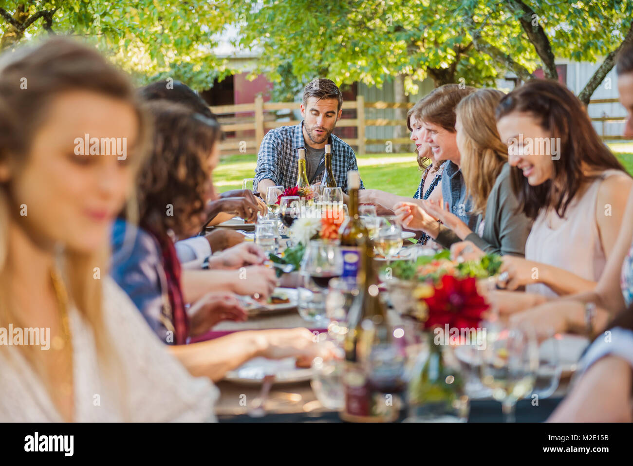 Friends enjoying wine at party outdoors Stock Photo