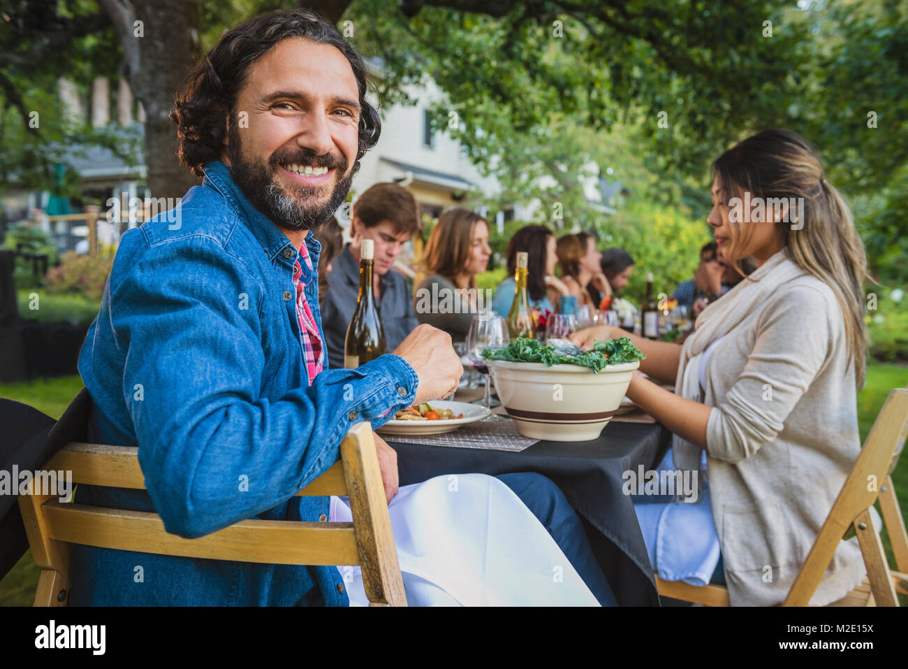 Portrait of smiling man at party outdoors Stock Photo