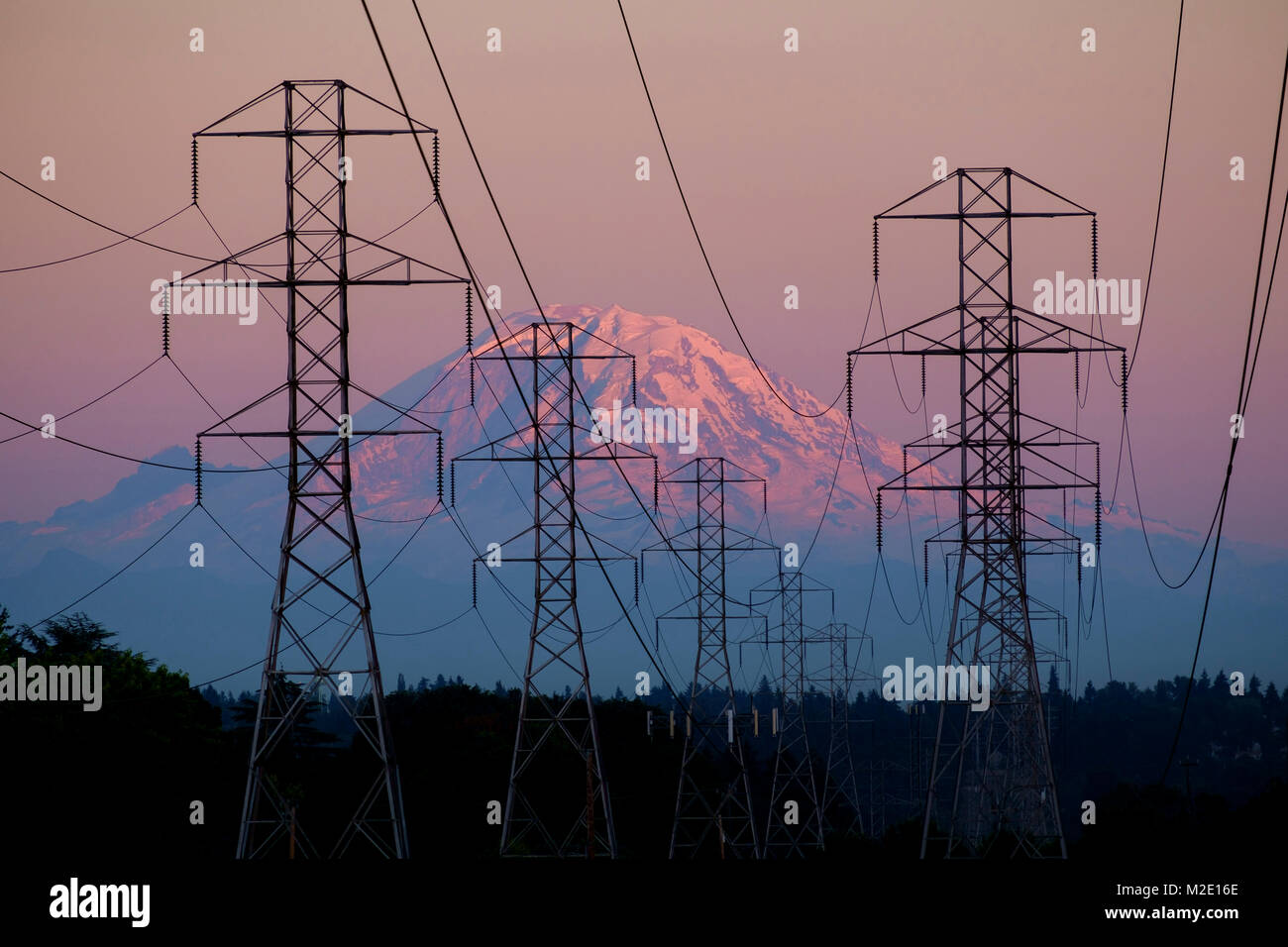 Electricity pylons near mountain landscape Stock Photo