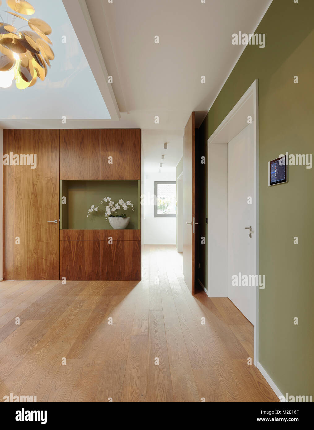 Plank floor and walnut wall covering in home Stock Photo